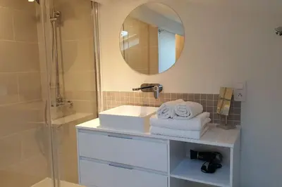 a bathroom with a sink and a mirror at Duplex Cannes plein Centre, Zone Piétonne, 2 Chambres in Cannes
