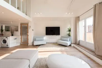 a living room with a couch and a tv at Duplex Cannes plein Centre, Zone Piétonne, 2 Chambres in Cannes