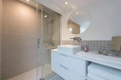 a bathroom with a sink and a glass shower at Duplex Cannes plein Centre, Zone Piétonne, 2 Chambres in Cannes