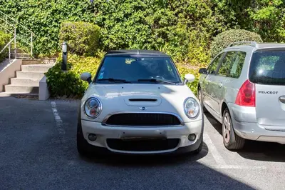 two cars parked next to each other in a parking lot at C9 - 2 BDR 10 min Palais Festivals & Sea - AC, Parking & Balcony in Cannes