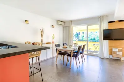 a kitchen and dining room with a table and chairs at C9 - 2 BDR 10 min Palais Festivals & Sea - AC, Parking & Balcony in Cannes