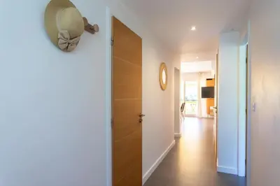 a hallway with a door with a mirror on the wall at C9 - 2 BDR 10 min Palais Festivals & Sea - AC, Parking & Balcony in Cannes