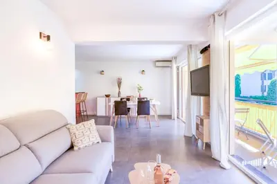 a living room with a couch and a table at C9 - 2 BDR 10 min Palais Festivals & Sea - AC, Parking & Balcony in Cannes