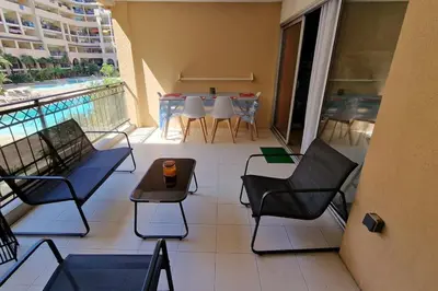 a balcony with chairs and a table on a balcony at WOW* mer/piscine/climat/parking in Cannes