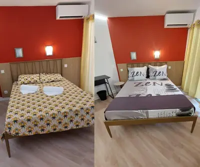 a bedroom with a bed and a red wall at WOW* mer/piscine/climat/parking in Cannes