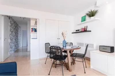 a kitchen and dining room with a table and chairs at Cocoon with garden near the sea in Cannes