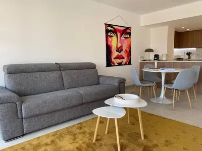 a living room with a couch and two tables at Paca properties -EC14- Appartements T2 - Cannes in Cannes