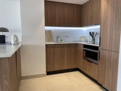 a kitchen with wooden cabinets and a sink at Paca properties -EC14- Appartements T2 - Cannes in Cannes