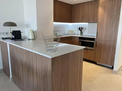 a kitchen with wooden cabinets and a counter top at Paca properties -EC14- Appartements T2 - Cannes in Cannes
