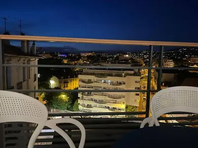 a balcony with two chairs and a view of a city at Paca properties -EC14- Appartements T2 - Cannes in Cannes