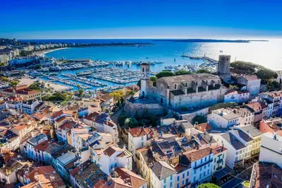 a bedroom with a large bed with a blue blanket at Studio Cannes Centre ville Festival - Internet Fibre - 2 Adultes et Couchage Enfant en option in Cannes