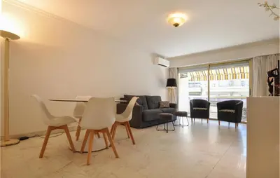 a living room with a table and chairs and a couch at 1 Bedroom Awesome Apartment In Cannes in Cannes