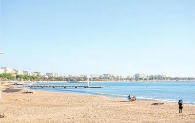 a group of people on a beach near the water at 1 Bedroom Awesome Apartment In Cannes in Cannes