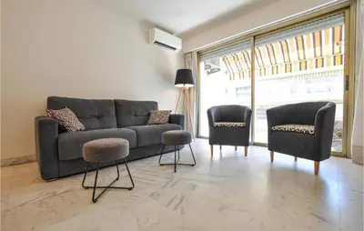 a living room with a couch and two chairs at 1 Bedroom Awesome Apartment In Cannes in Cannes