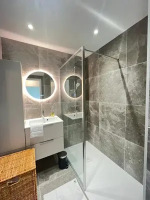 a bathroom with a glass shower and a sink at Les yeux dans le bleu, Cannes Vue mer in Cannes