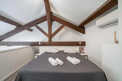 a bedroom with a bed with two white towels at Hypercentre - Palais - Croisette - Suquet - AY in Cannes