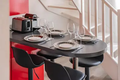 a table with wine glasses and a toaster at Hypercentre - Palais - Croisette - Suquet - AY in Cannes