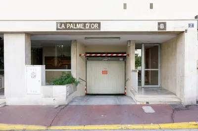 a building with a garage with a sign that reads la palma dur at Royal Palm YourHostHelper in Cannes