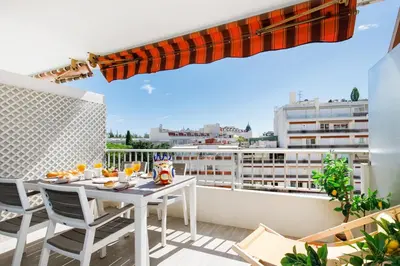 a balcony with a table and chairs on a balcony at Royal Palm YourHostHelper in Cannes