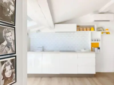 a kitchen with black and white photos on a wall at Le Bardot Croisette - Proche Palais & Mer - Climatisation in Cannes