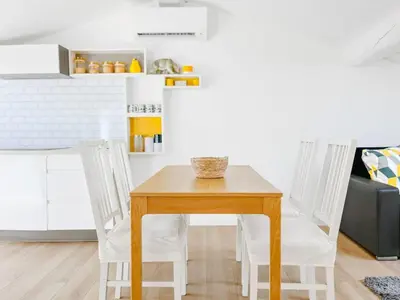 a table and two white chairs in a kitchen at Le Bardot Croisette - Proche Palais & Mer - Climatisation in Cannes