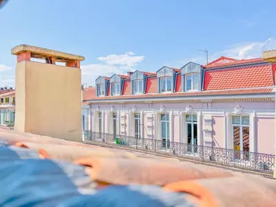 a row of buildings with red roofs on a street at Le Bardot Croisette - Proche Palais & Mer - Climatisation in Cannes