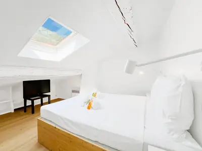 a white bedroom with a bed and a television at Le Bardot Croisette - Proche Palais & Mer - Climatisation in Cannes