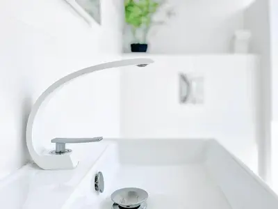 a white bathroom sink with a faucet at Le Bardot Croisette - Proche Palais & Mer - Climatisation in Cannes