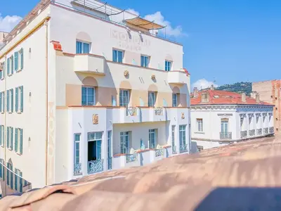 a large white building on top of a roof at Le Bardot Croisette - Proche Palais & Mer - Climatisation in Cannes