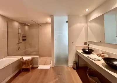 a bathroom with a tub and a sink and a shower at Rumah Bali in Cannes