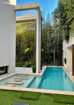 a swimming pool in the backyard of a house at Rumah Bali in Cannes