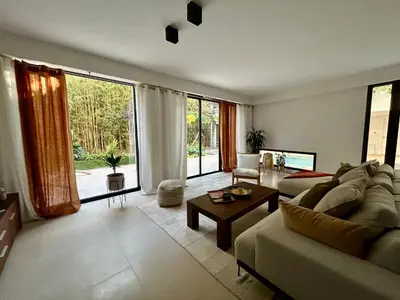 a living room with a couch and a table at Rumah Bali in Cannes