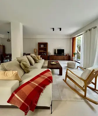 a living room with a couch and a table at Rumah Bali in Cannes