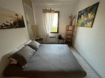 a large bed in a bedroom with a window at Chambre privé avec Sdb privative in Le Cannet