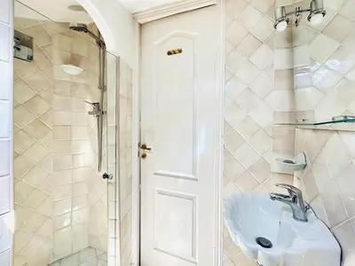 a bathroom with a sink and a shower at Place du Suquet - Terrasse - 3 Chambres - Parking in Cannes