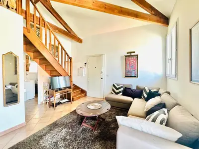 a living room with a couch and a table at Place du Suquet - Terrasse - 3 Chambres - Parking in Cannes