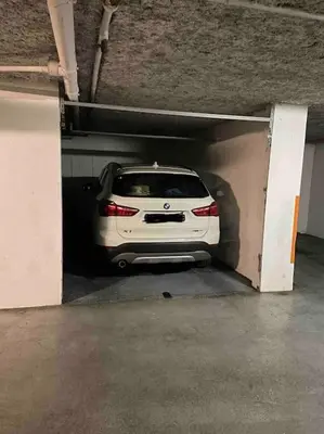 a white car is parked in a parking garage at Appartement, 2 pièces ,résidence avec piscine in Cannes