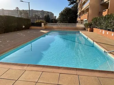 a large blue swimming pool in a building at Appartement, 2 pièces ,résidence avec piscine in Cannes