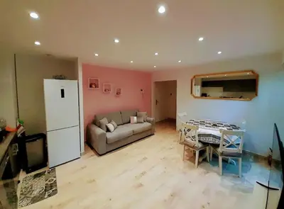 a living room with a couch and a table at Appartement 2 pièces dans résidence avec piscine Isola Bella in Cannes