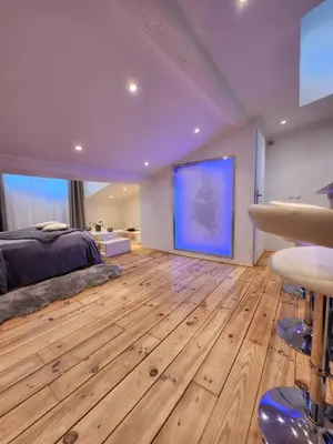 a bedroom with a large bed and a blue screen at Le Croisette center in Cannes