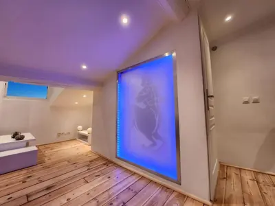 a large blue painting on a wall in a room at Le Croisette center in Cannes