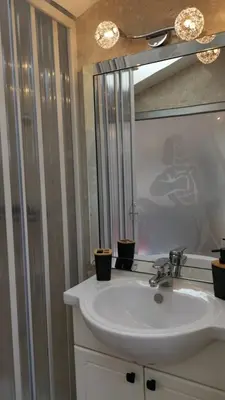 a bathroom with a white sink and a mirror at Le Croisette center in Cannes