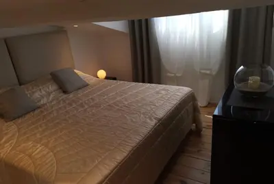a bedroom with a large bed and a window at Le Croisette center in Cannes