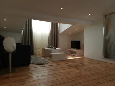 a living room with wooden floors and a large window at Le Croisette center in Cannes