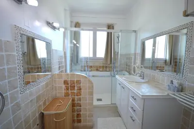 a bathroom with two sinks and a shower with mirrors at 