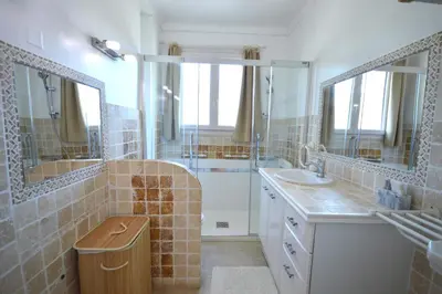 a bathroom with two sinks and a shower with mirrors at 