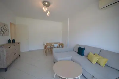 a living room with a blue couch and a table at 