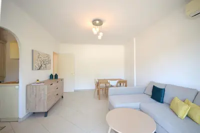 a living room with a blue couch and a table at 