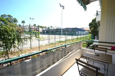 a balcony with two benches and a view of a street at 