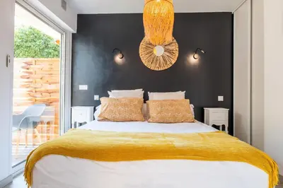 a bedroom with a bed and a black wall at Cozy 1-Br Apartment heart of Palm Beach district in Cannes